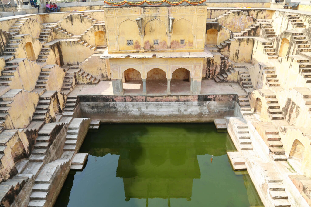Top-down view of Amer Fort with intricate architecture symmetrical stairways and central stepwell Wallpaper