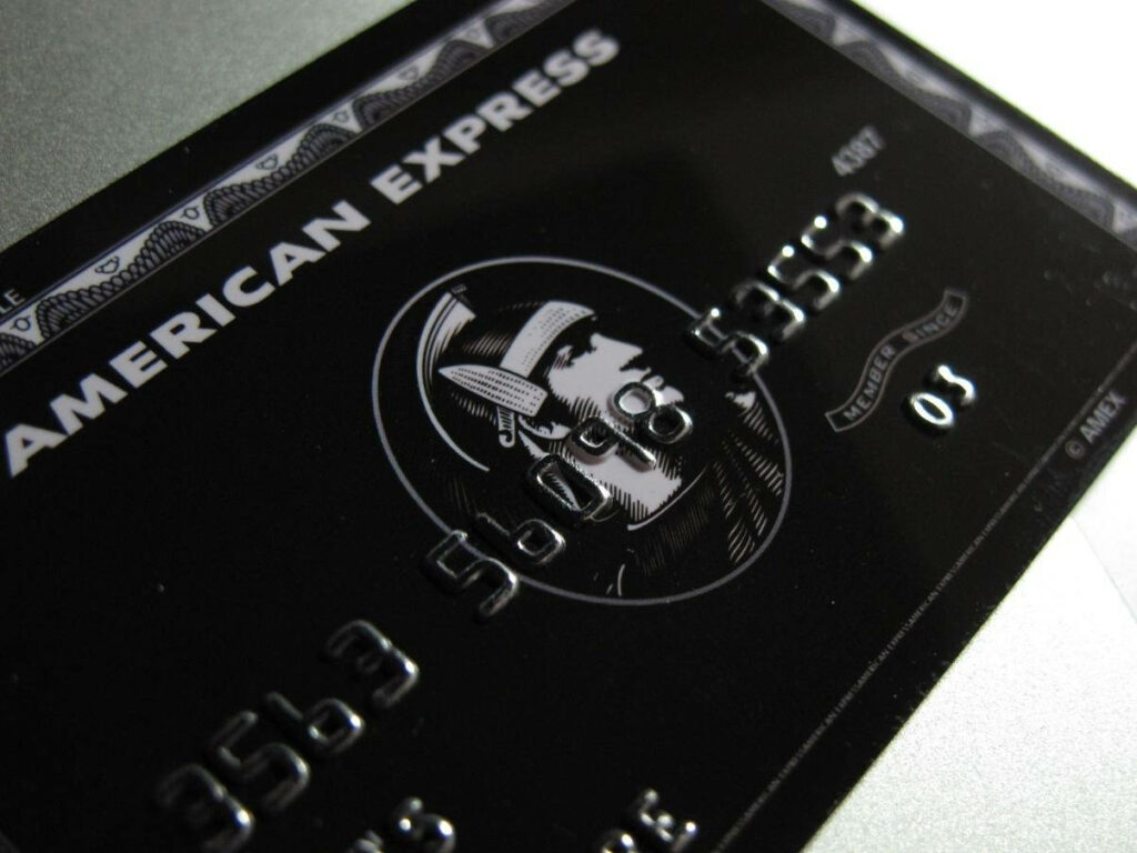 Close-up of American Express Black Card with sleek embossed design symbolizing prestige and exclusivity Wallpaper