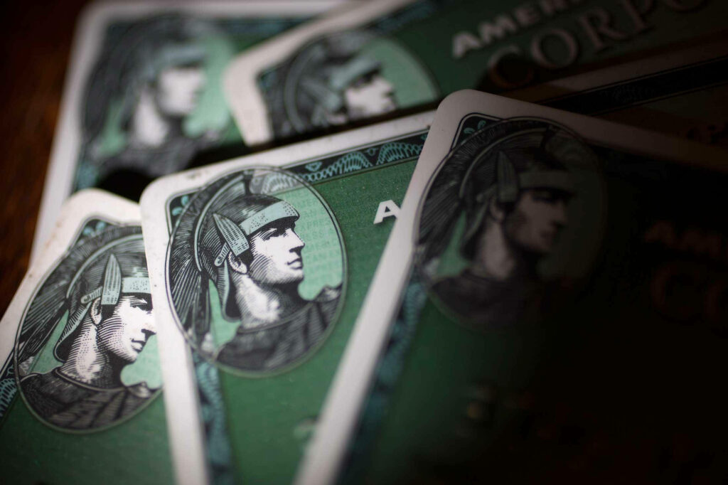 Close-up of green American Express Corporate Cards with centurion emblem symbolizing business power Wallpaper