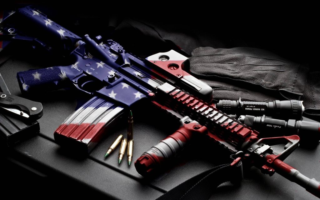 American flag AR-15 rifle wallpaper with Trijicon optic Fenix Olight flashlights cartridges gloves