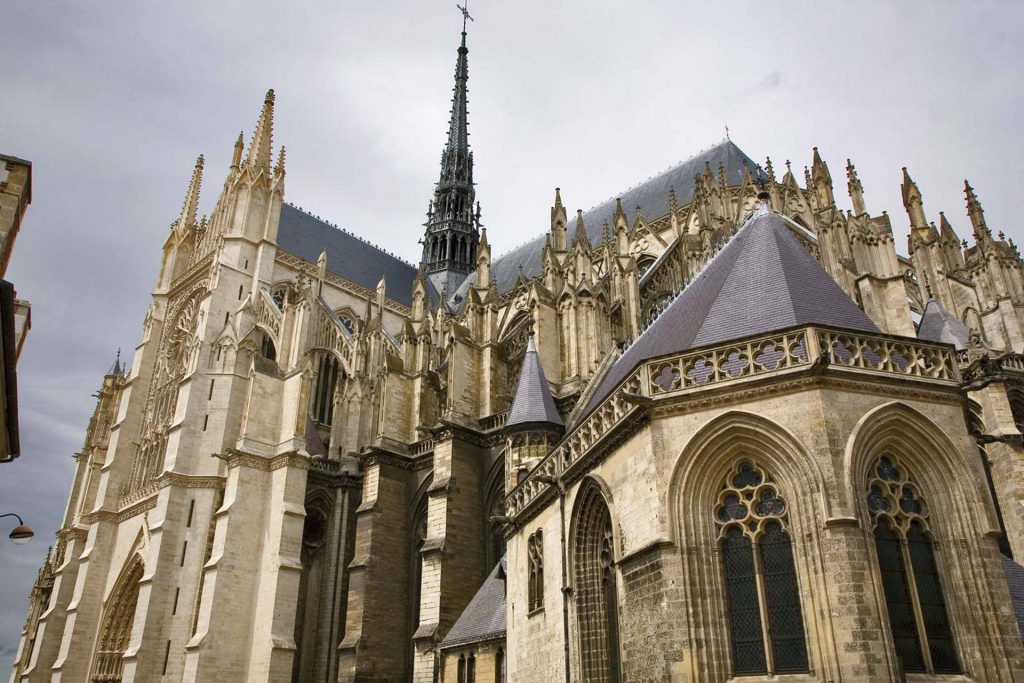 Amiens Cathedral Gothic architecture with spires flying buttresses detailed stonework wallpaper