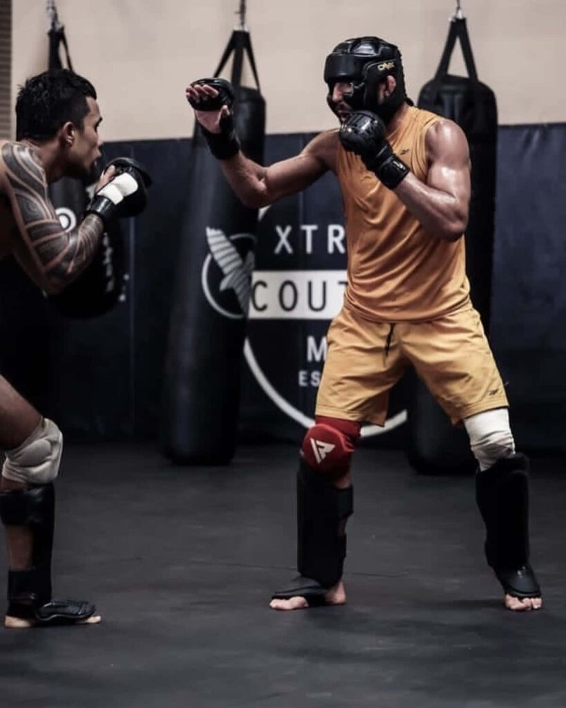 Amir Albazi: Intense Punch Training in Professional Gym Wallpaper