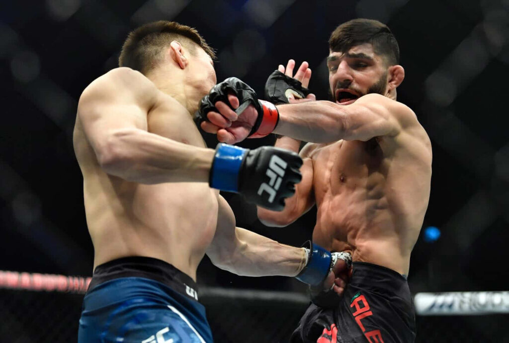 Amir Albazi lands a powerful UFC punch in the octagon showcasing intense fight action wallpaper