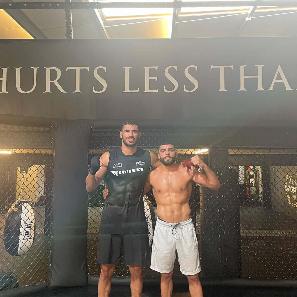 Amir Albazi and Ricardo Ramos in training cage showing athletic build and competitive spirit wallpaper