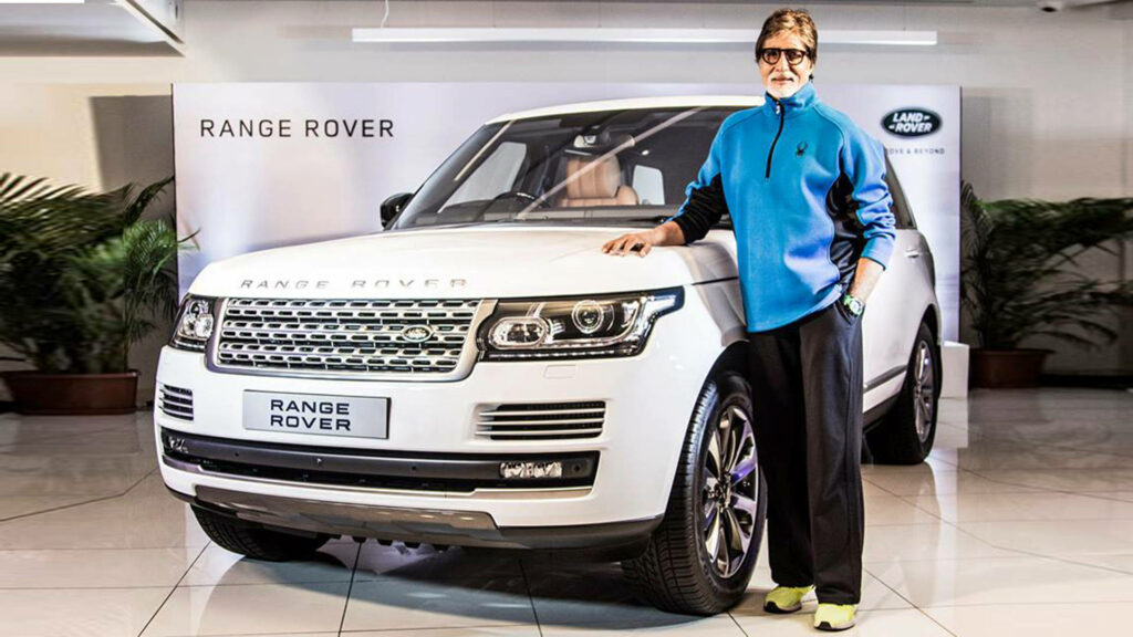 Amitabh Bachchan stands confidently beside a luxurious white Range Rover showcasing elegance and style Wallpaper