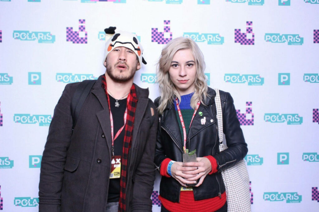 Amy Nelson and attendee pose at PAX event in front of Polaris-themed wallpaper backdrop