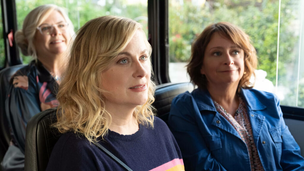 Amy Poehler and friends smiling on a scenic Wine Country bus tour girls getaway wallpaper background