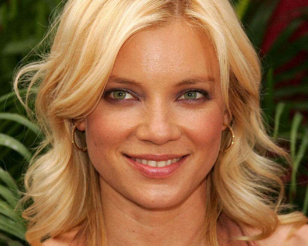Amy Smart smiling outdoors with styled blonde hair bright cheerful natural background wallpaper