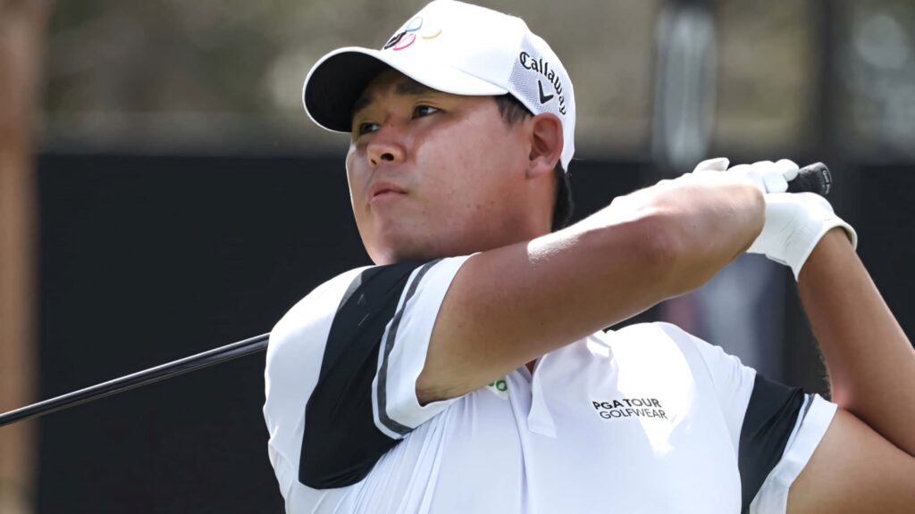 An Byeong-hun focused golf swing athletic form crisp attire dynamic outdoor lighting wallpaper
