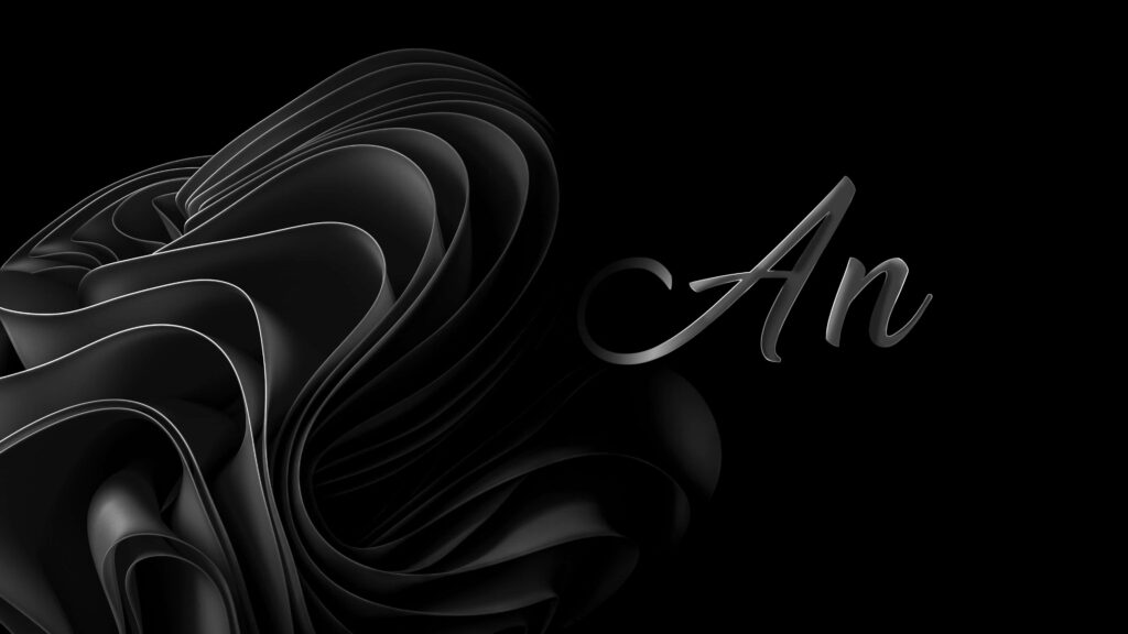 The Essence of Elegance: A Minimalist Black Wallpaper with 'an' in Sleek Typography and a Dramatic Draped Fabric Accent