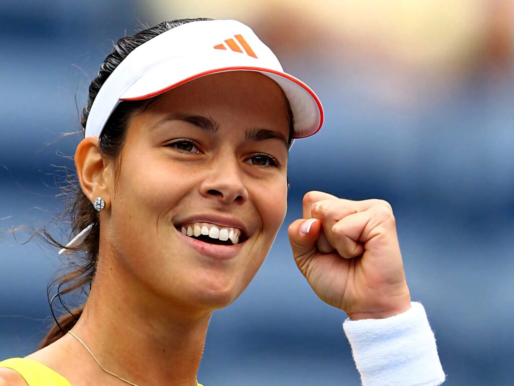 Ana Ivanović celebrating victory with raised fist and confident smile tennis wallpaper background