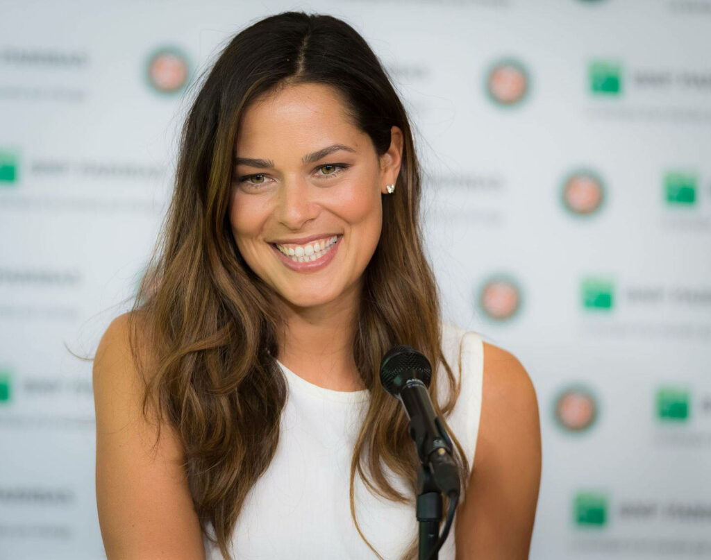 Ana Ivanović smiling in interview with sponsor logo backdrop professional engaging wallpaper background