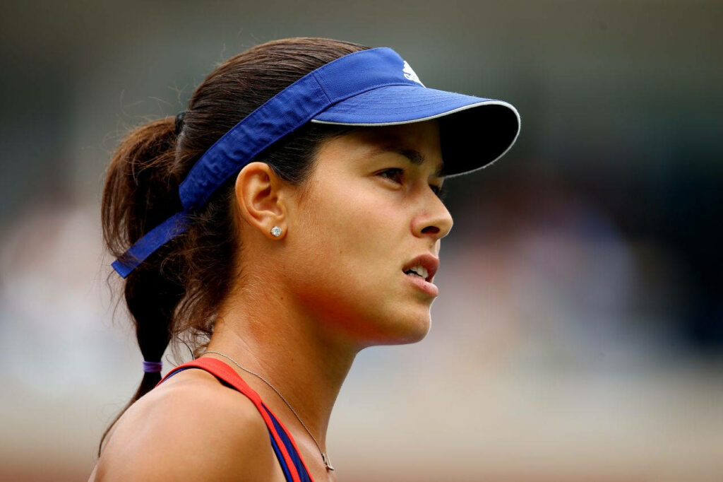 Ana Ivanović focused and thoughtful on tennis court inspiring wallpaper background image