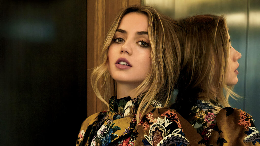 Ana de Armas leaning on reflective surface wearing floral outfit stylish wallpaper background