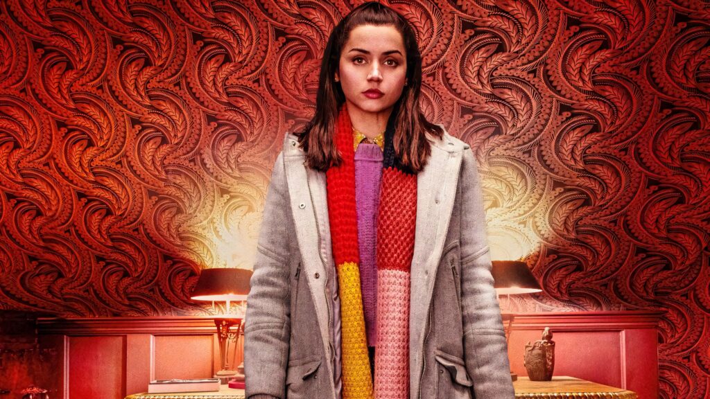 Ana de Armas in iconic Knives Out outfit against rich red patterned wallpaper background