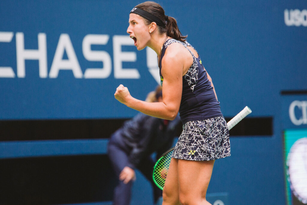 Anastasija Sevastova tennis player celebrating intense competitive point on court wallpaper background
