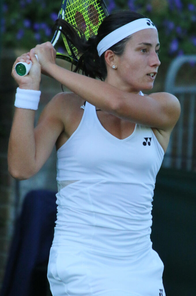 Anastasija Sevastova concentrating on backhand shot holding tennis racket in match close-up Wallpaper