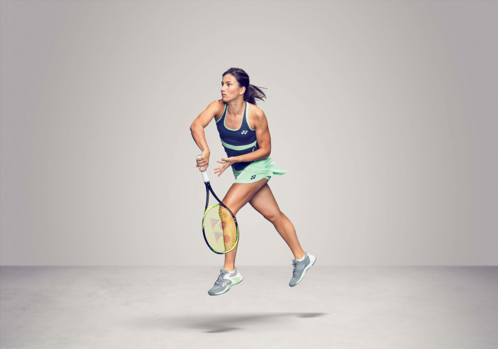 Anastasija Sevastova mid-air powerful tennis shot dynamic sports photoshoot wallpaper background