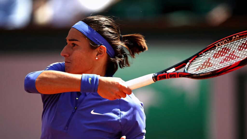 Anastasija Sevastova intense tennis swing action wallpaper showcasing athleticism and focus