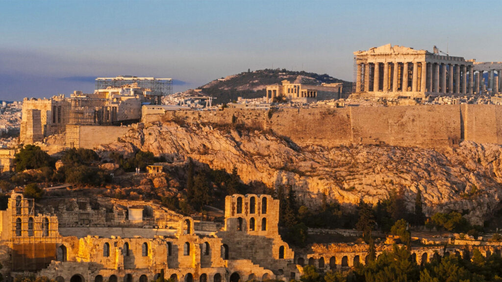Ancient Parthenon and historic Athens ruins bathed in golden sunlight wallpaper background