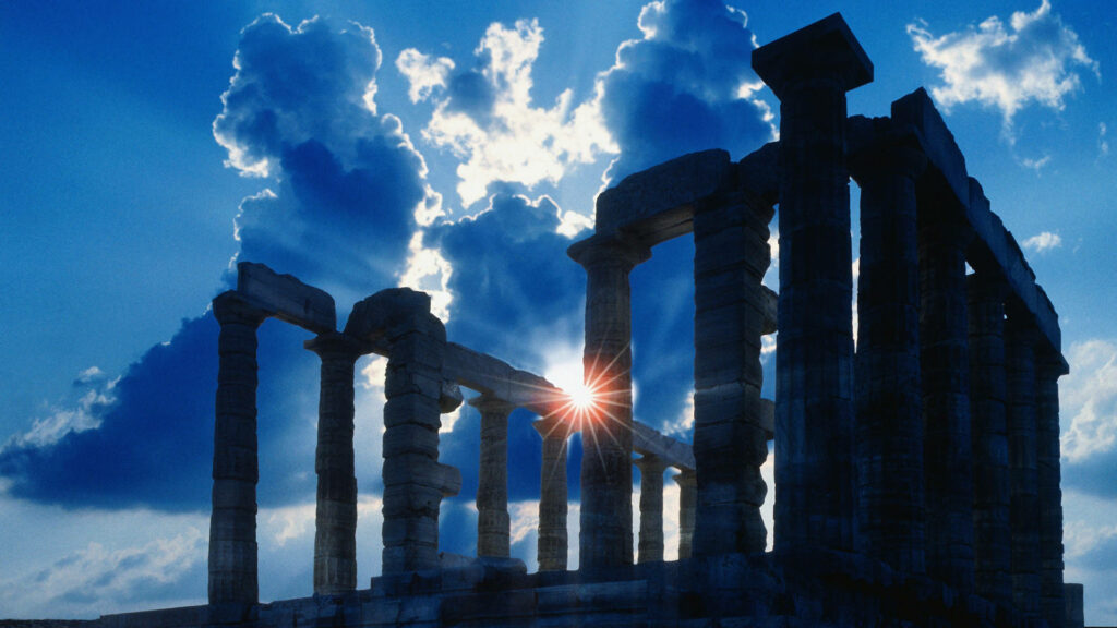 Silhouette of ancient Athens temple with sun rays and dramatic clouds against vivid blue sky Wallpaper