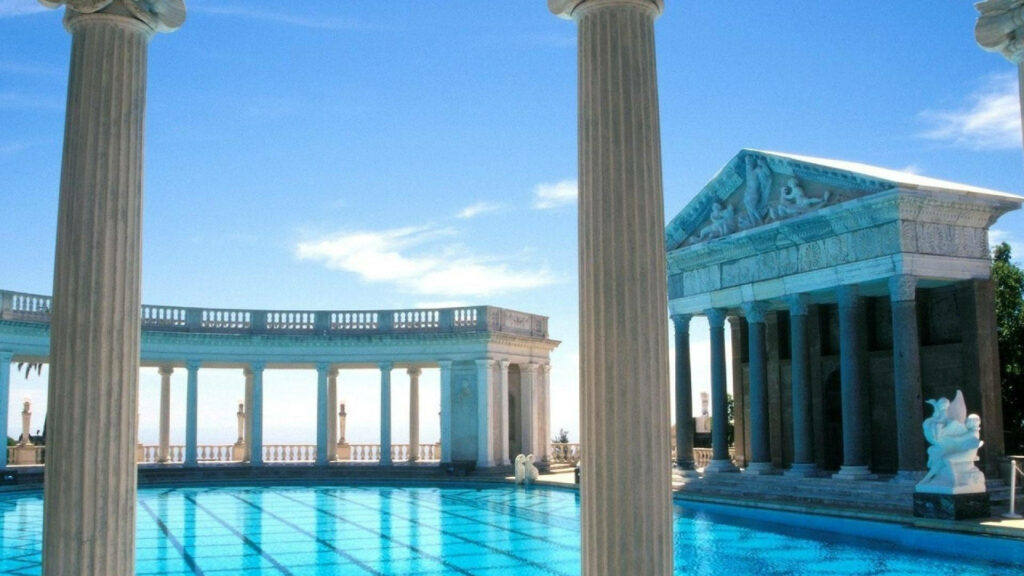 Elegant pool with Athens-inspired classical columns marble statues and clear blue sky wallpaper