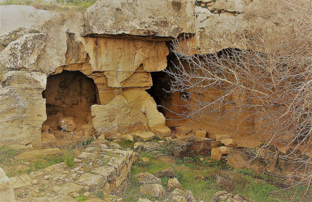 Ancient Rock-Cut Tombs Wallpaper with Weathered Stone Texture Background