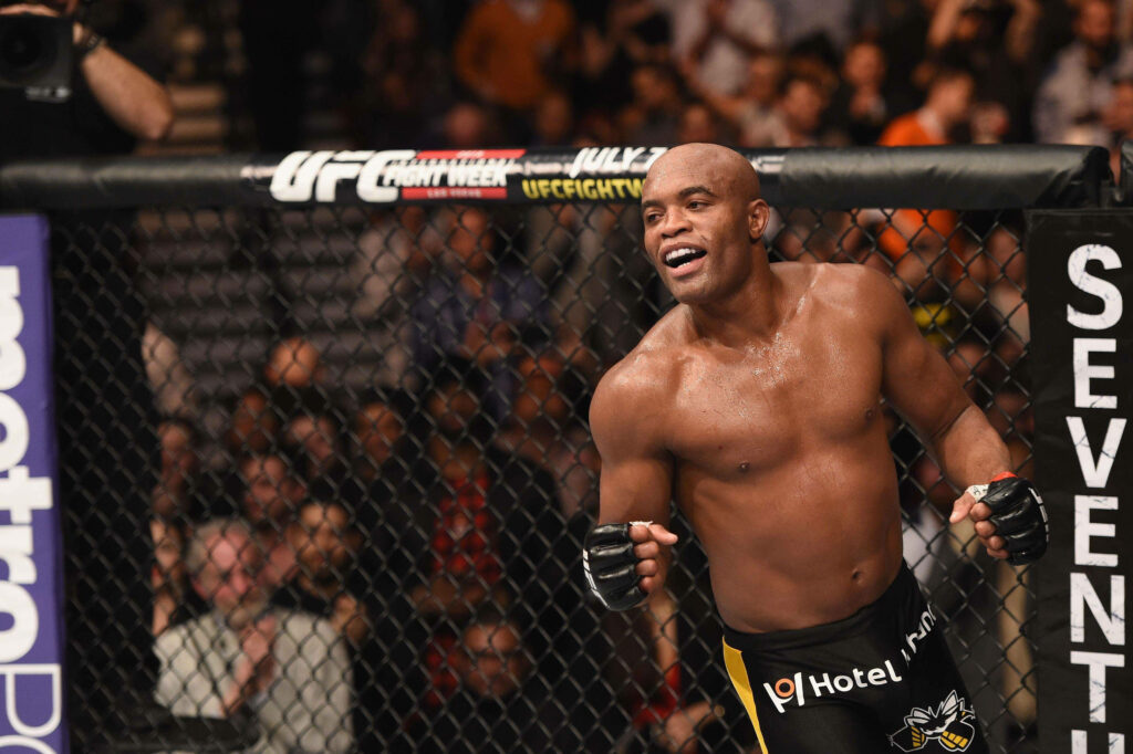 Anderson Silva smiling and celebrating inside the UFC octagon dynamic fight wallpaper background