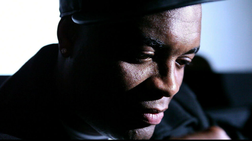 Anderson Silva contemplative pose face partially illuminated deep in thought wallpaper background