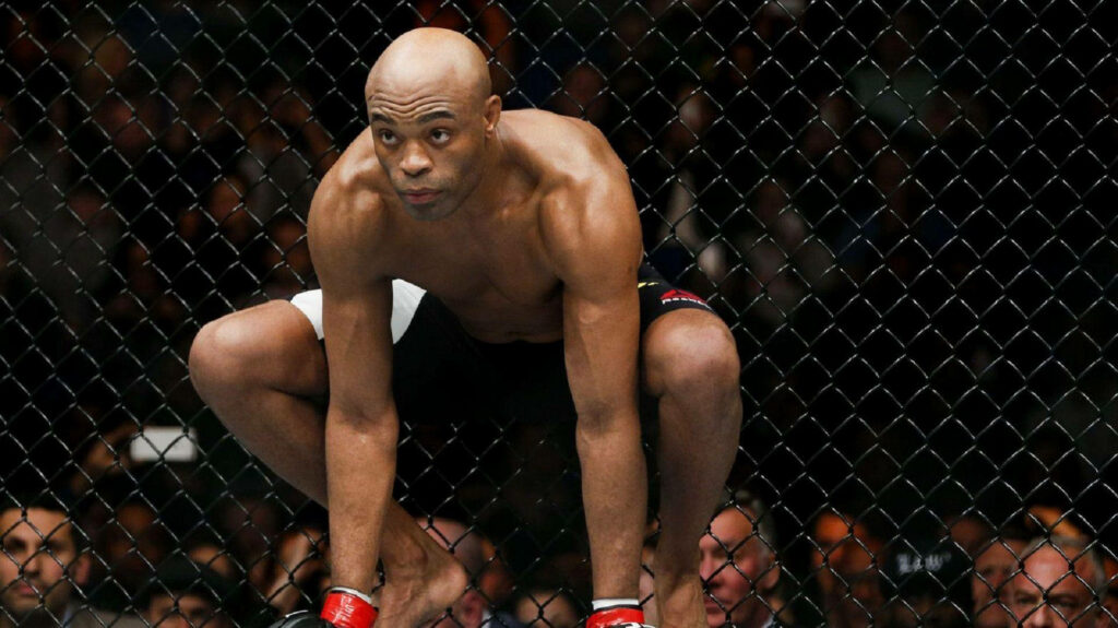 Anderson Silva crouched in octagon ready to fight showing intense focus and athleticism wallpaper