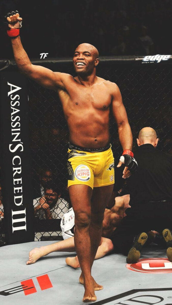 Anderson Silva confident in octagon with Assassin's Creed III promotional banners background wallpaper