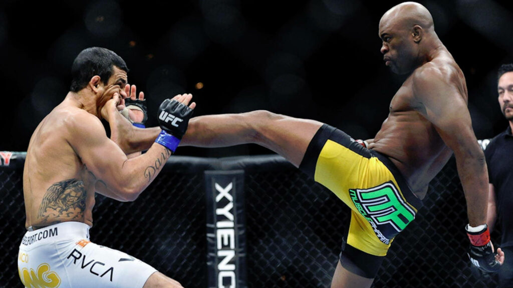 Anderson Silva executes a powerful head kick in the octagon showcasing MMA striking skills Wallpaper