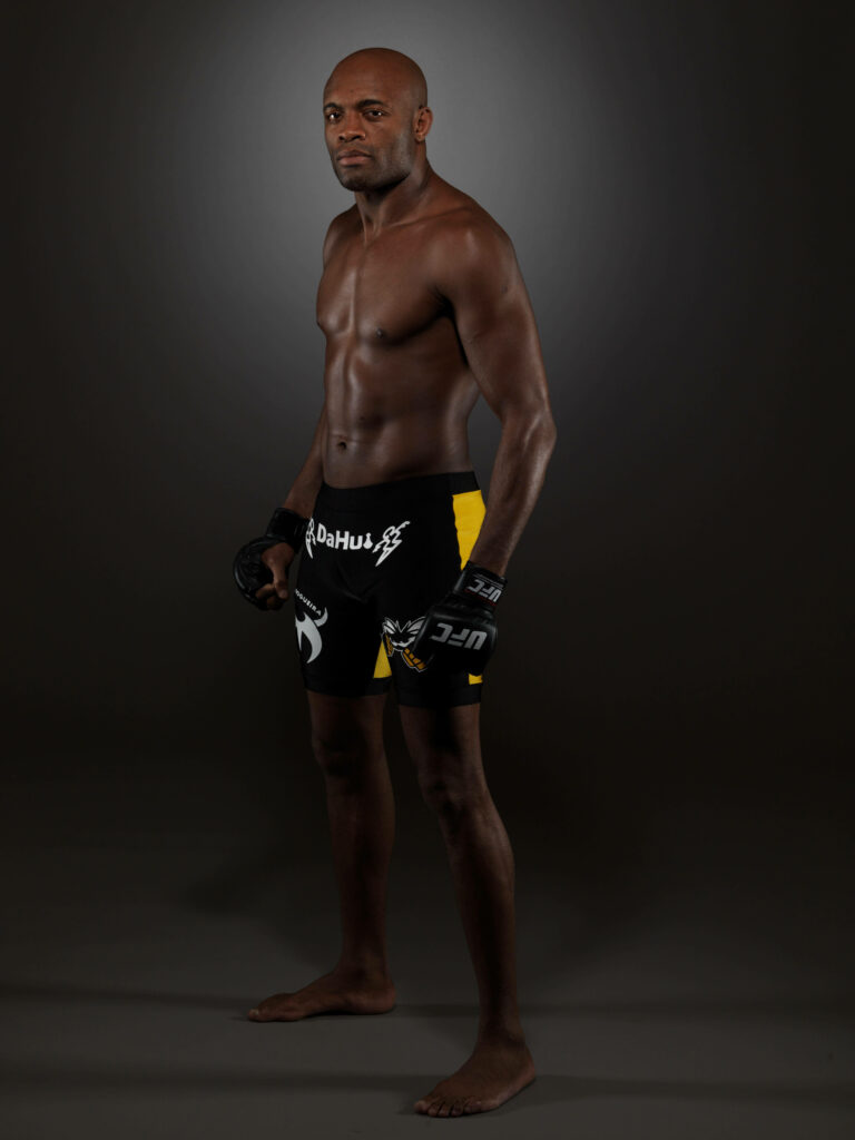 Anderson Silva UFC fighter in fighting pose with gloves against dark athletic wallpaper background