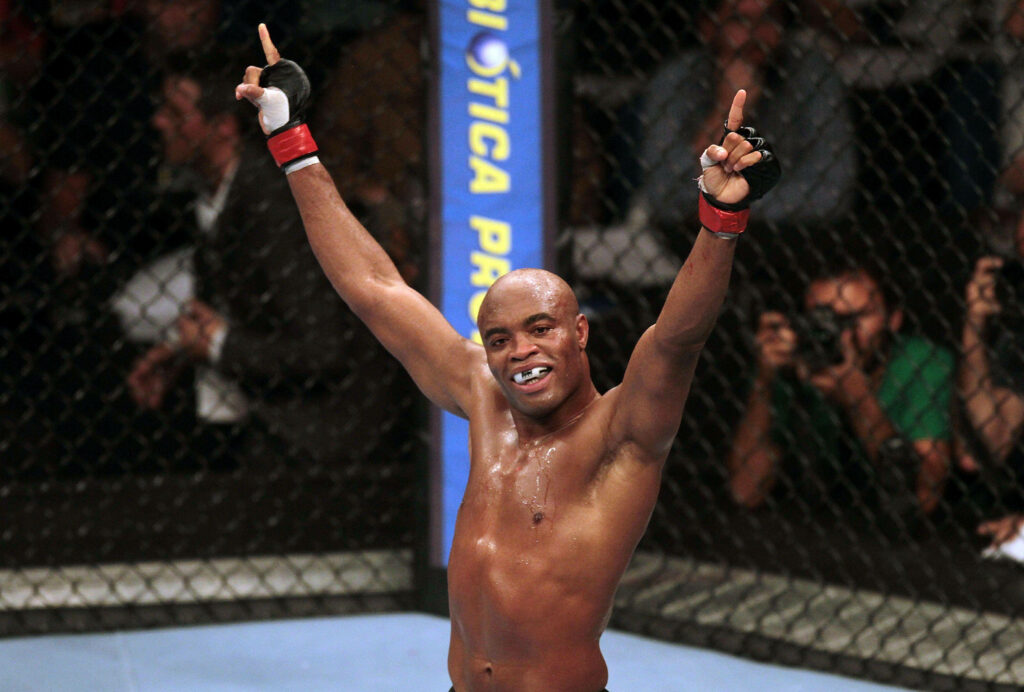 Anderson Silva celebrates UFC victory in the octagon pointing hands upward confident wallpaper