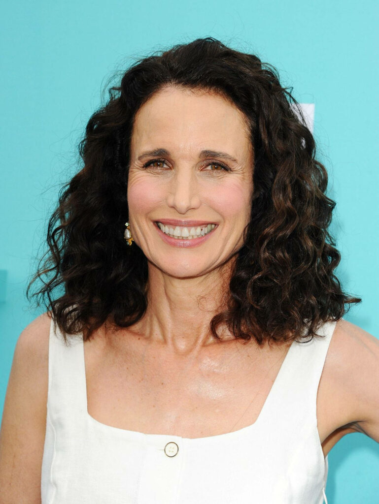 Andie MacDowell radiant curly hair bright smile turquoise background celebrity wallpaper