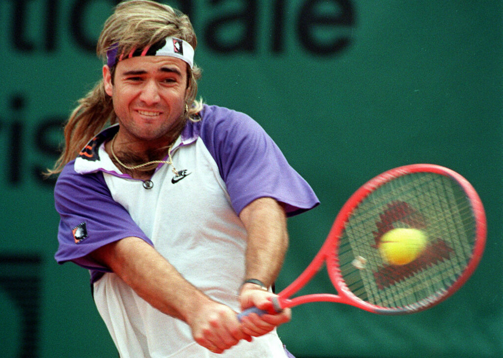 Andre Agassi’s Powerful Backhand: Tennis Wallpaper Background