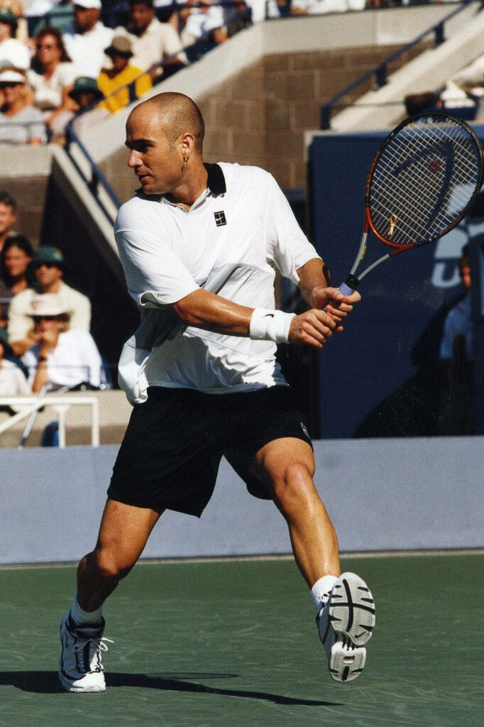 Andre Agassi Mid-Action Tennis Court Wallpaper: Agility & Focus