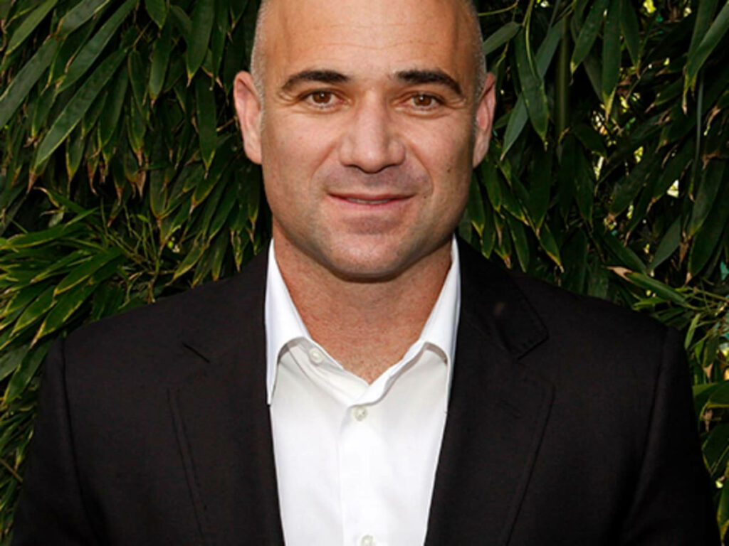 Andre Agassi Smiling in Sharp Suit - Lush Green Wallpaper Background