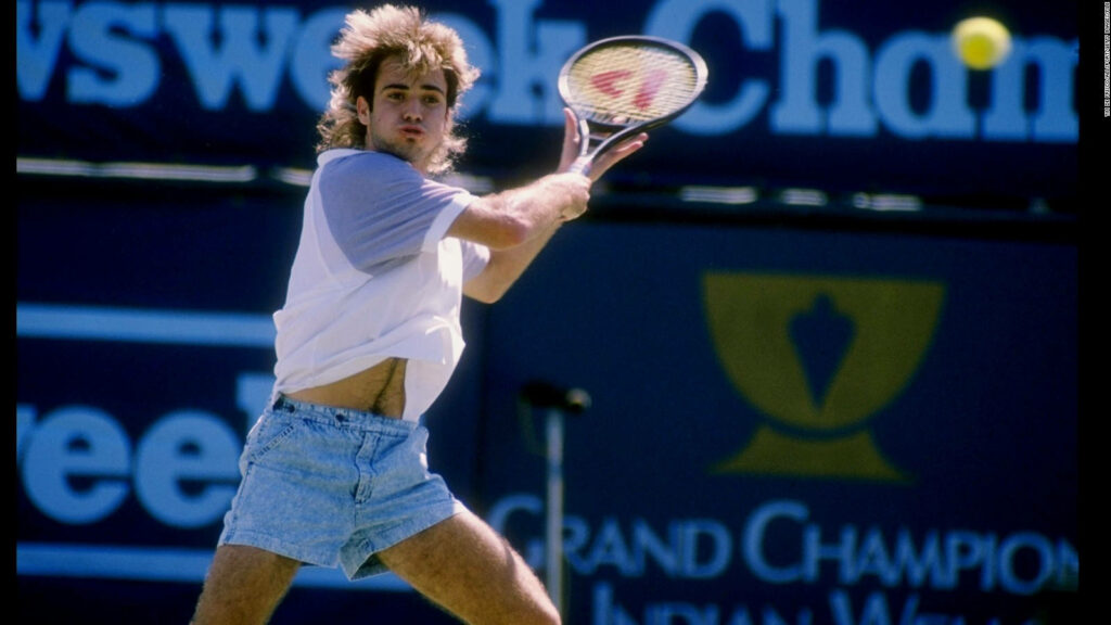 Andre Agassi in Denim Shorts: Tennis Action Wallpaper Background