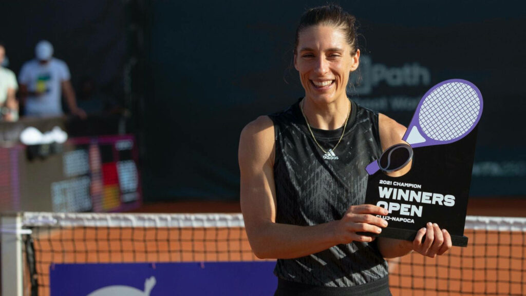 Andrea Petkovic celebrates seventh WTA title holding Winners Open trophy on tennis court wallpaper