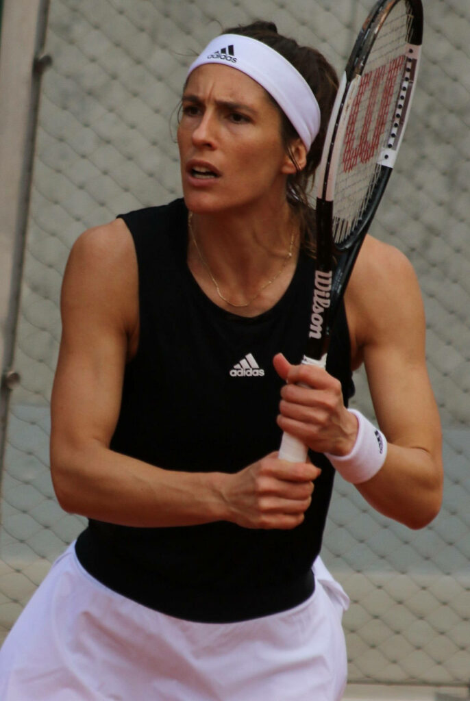 Andrea Petkovic German tennis player focused preparing shot wearing Adidas gear and white headband Wallpaper