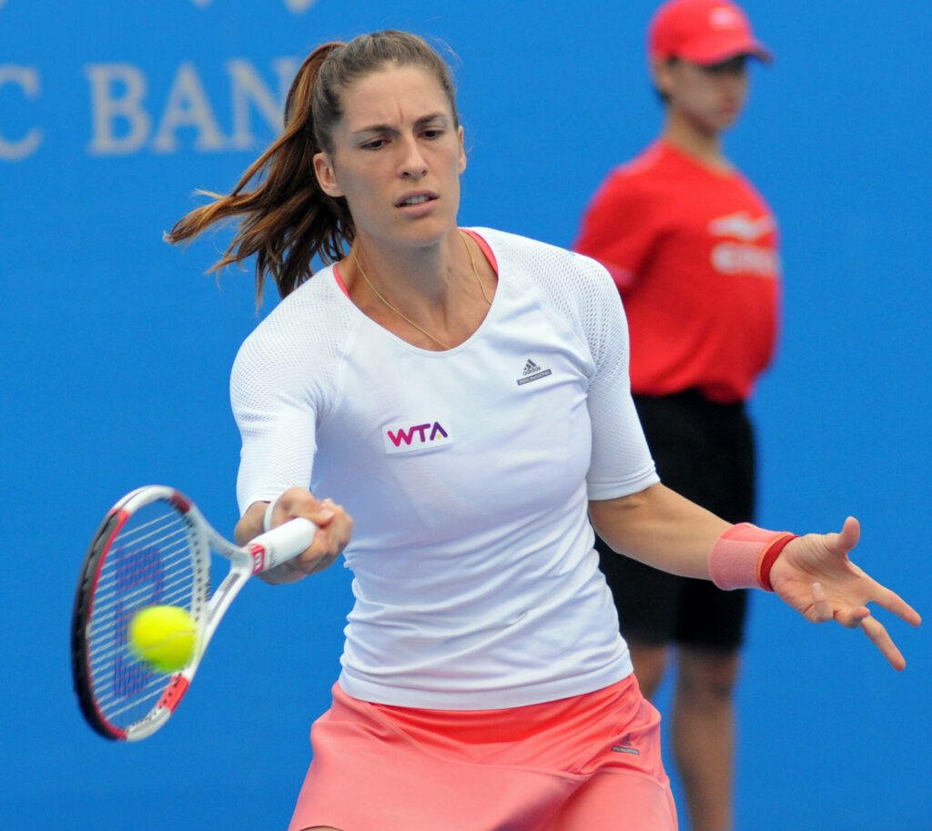 Andrea Petkovic preparing forehand shot on tennis court displaying athleticism and focus Wallpaper