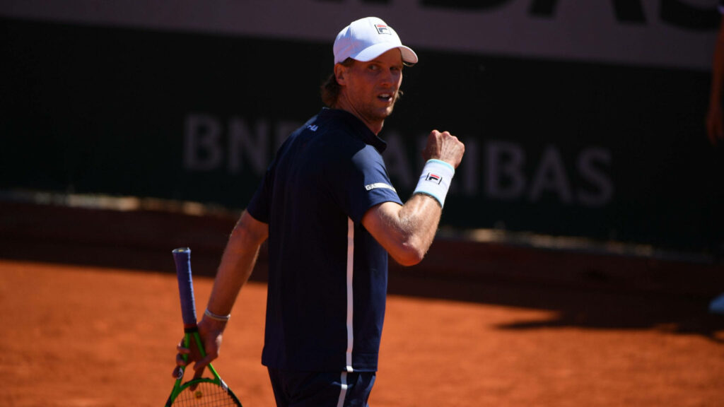 Andreas Seppi looking back on clay tennis court holding racquet dynamic sports wallpaper background