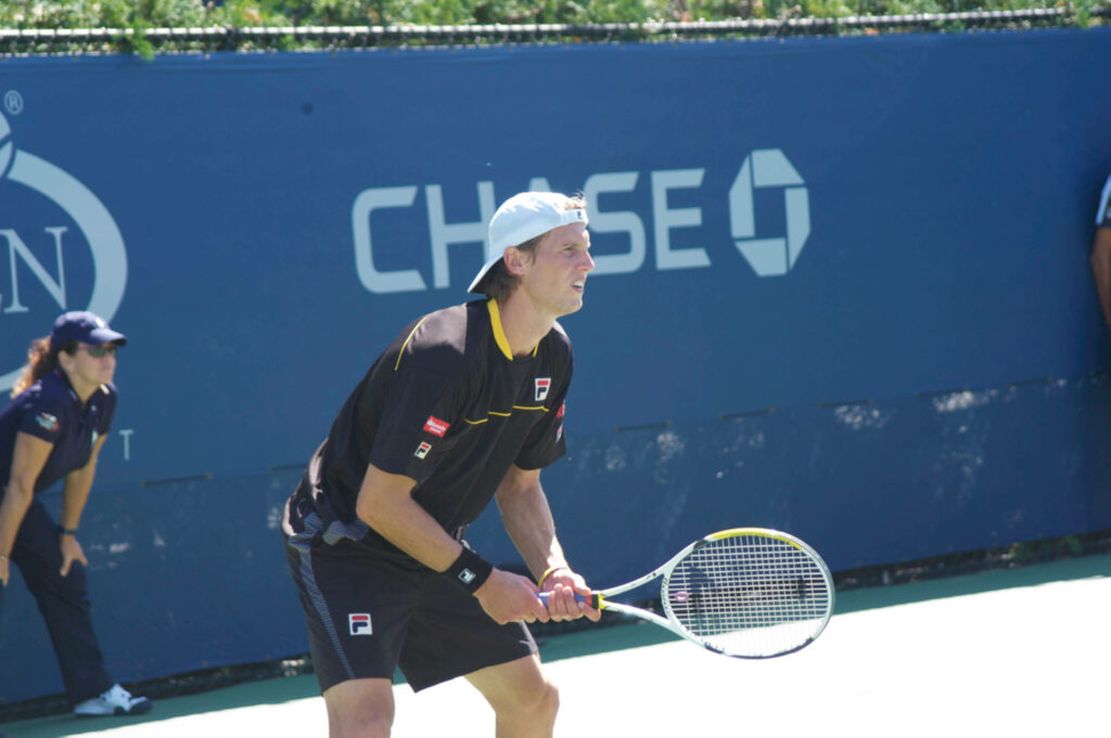 Andreas Seppi focused receiving serve on outdoor hard court tennis match wallpaper background