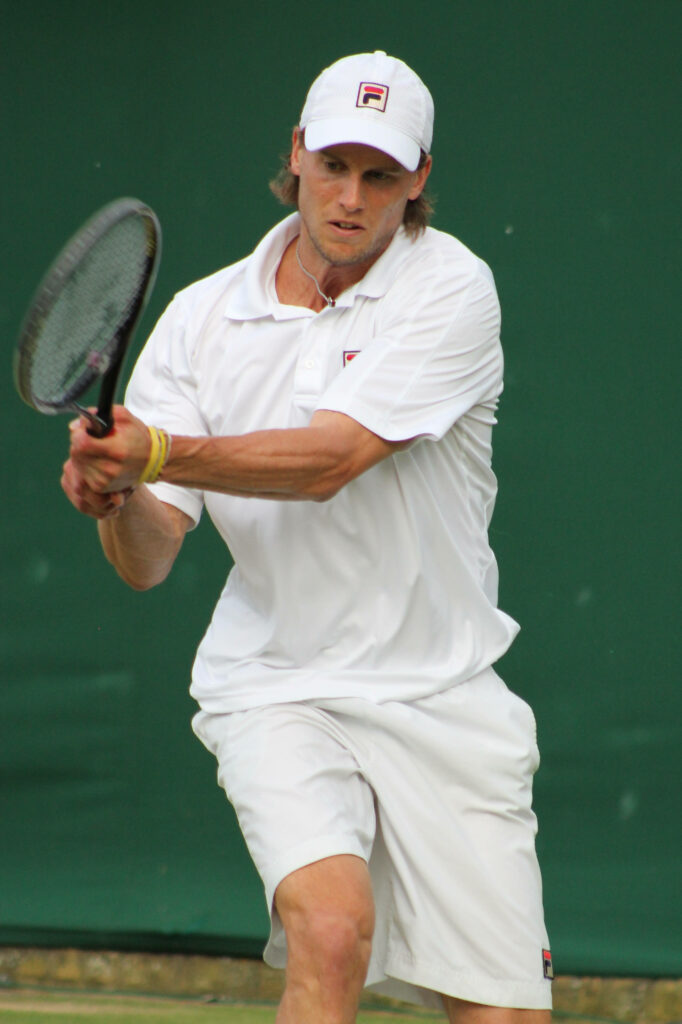 Tennis player Andreas Seppi with shoulder-length hair focused during intense match action wallpaper