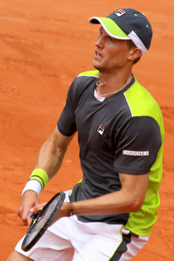 Andreas Seppi focused tennis player hitting shot on clay court showing skill and determination Wallpaper