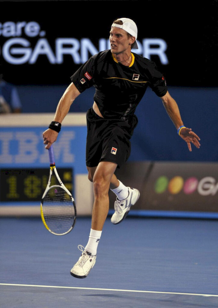 Andreas Seppi mid-jump on tennis court displaying athleticism and intense focus during match Wallpaper