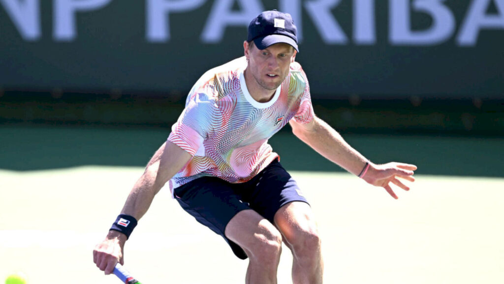 Andreas Seppi playing tennis in colorful top focused intense action vibrant outdoor court background Wallpaper