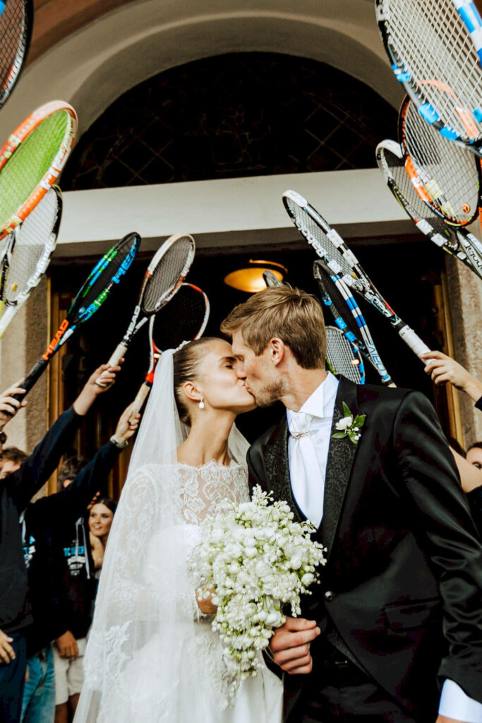 Andreas Seppi and wife share wedding day kiss with friends holding tennis rackets celebration wallpaper