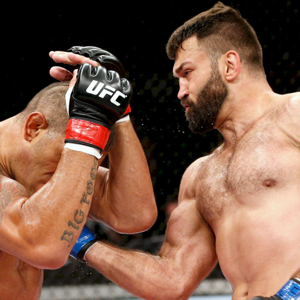 Andrei Arlovski punches Antonio Bigfoot Silva in intense UFC mixed martial arts fight wallpaper background